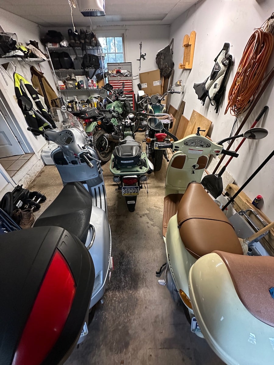 scooters and motorcycles in a garage