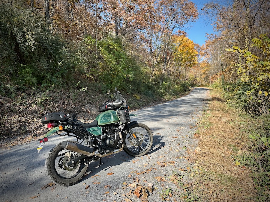 Royal Enfield Himalayan motorcycle on a gravel road.