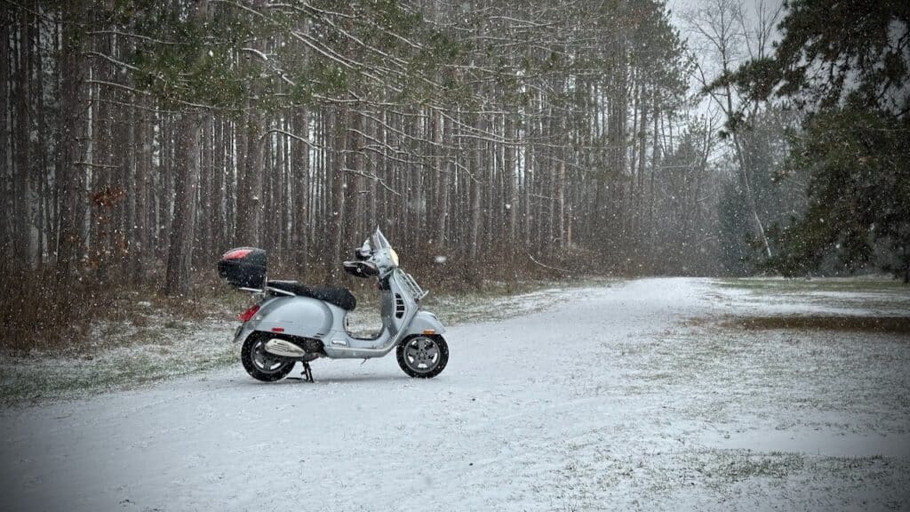 Vespa GTS 250 scooter in the snow.