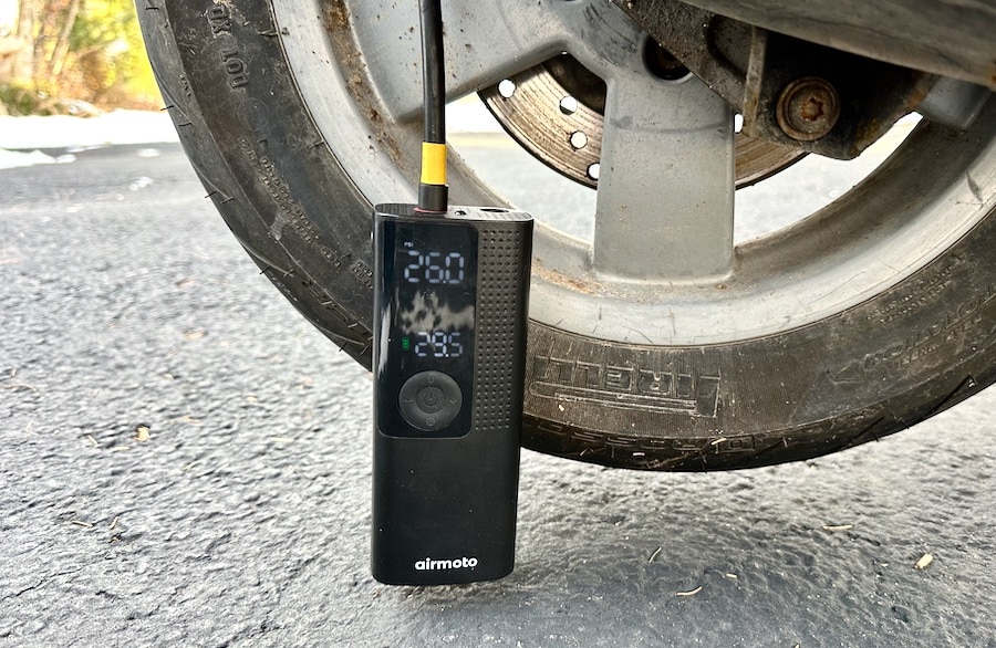 Air pump attached to a scooter tire.