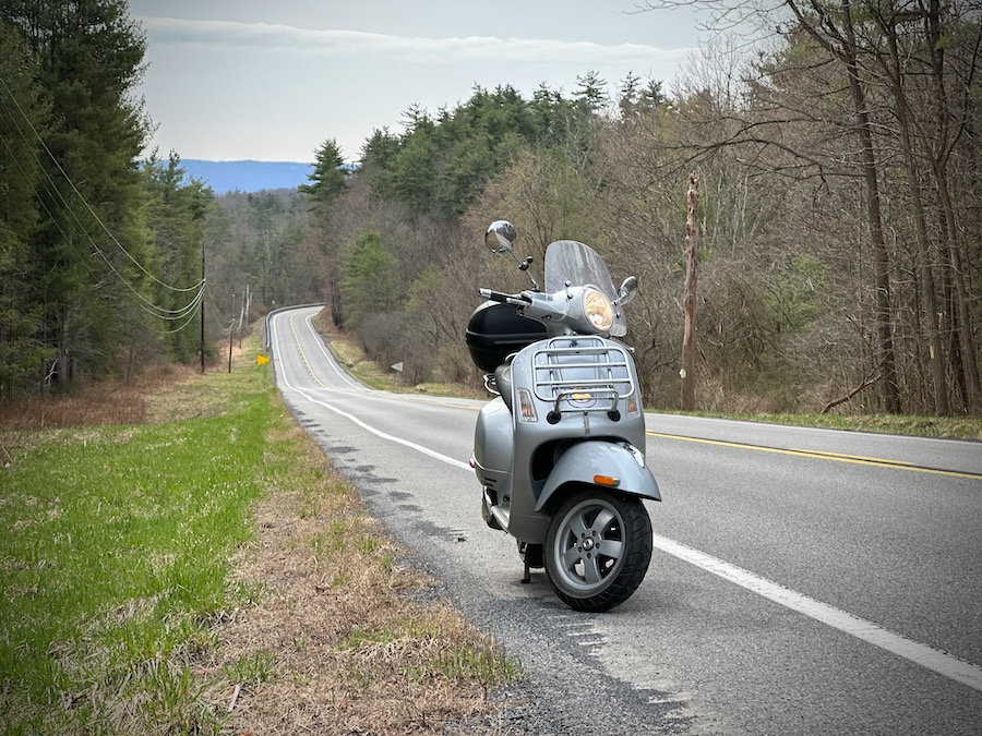 Vespa GTS scooter on a rural road.