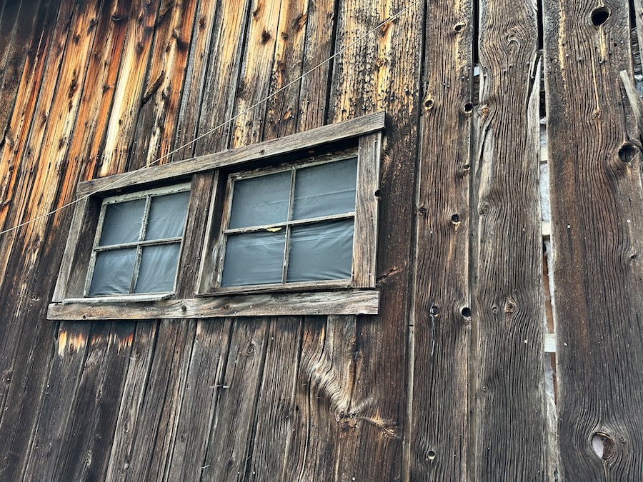 Old weathered wooden barn siding and windows.