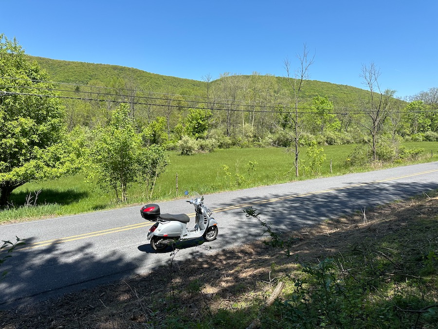 Vespa GTS 250 scooter on a rural road.