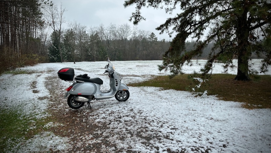 Vespa GTS scooter in the snow.