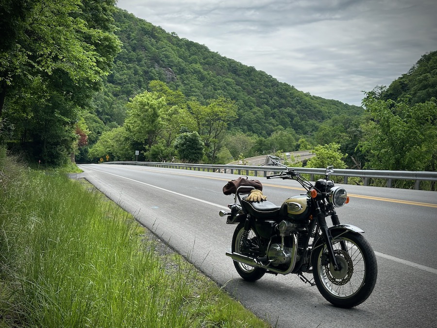 2001 Kawasaki W650 parked along a rural road.