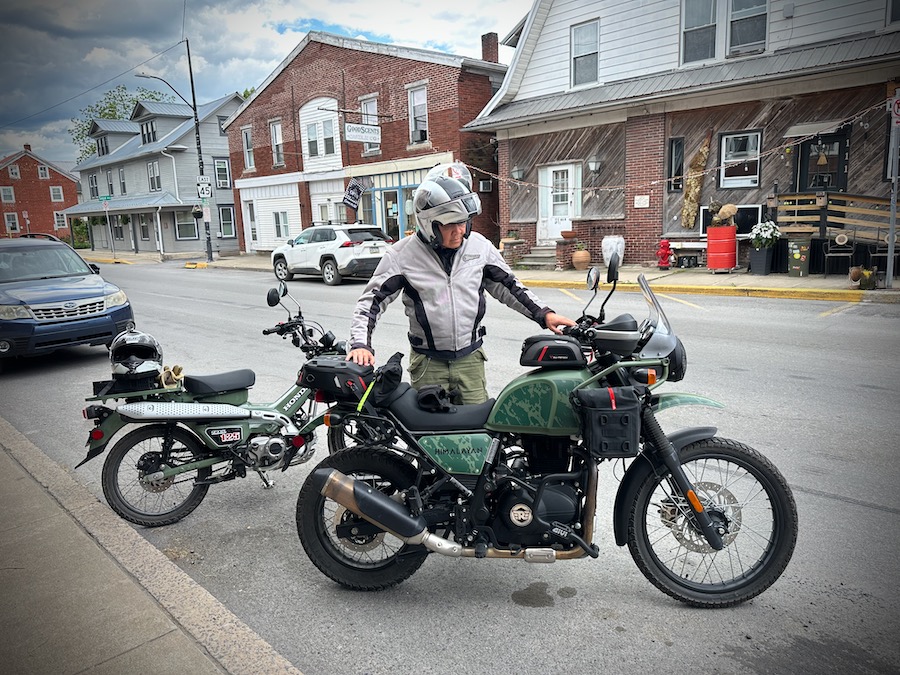 Man with a Royal Enfield Himalayan motorcycle.