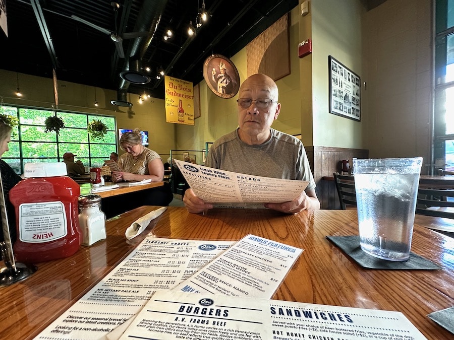 Dom Chang looking at a menu in Otto's restaurant in State College, Pennsylvania.
