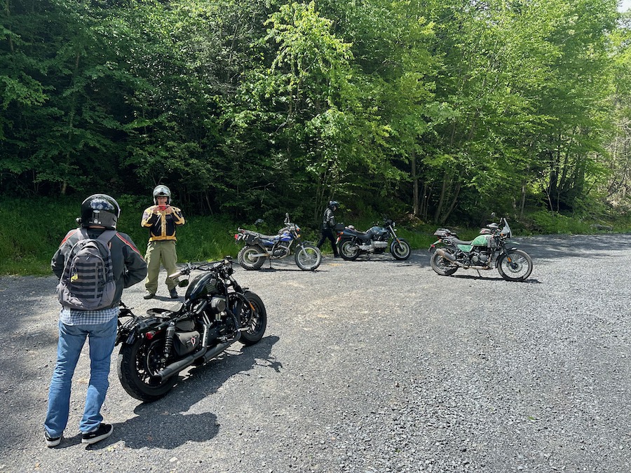 Four motorcycles and riders.