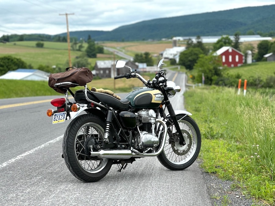 Portrait of a 2001 Kawasaki W650 along a road.