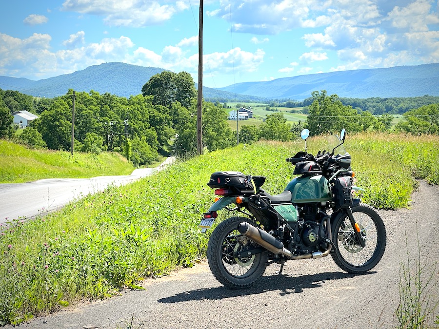 Royal Enfield Himalayan motorcycle parked along a rural road.