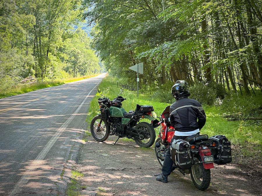 Two motorcycles stopped along a rural road.