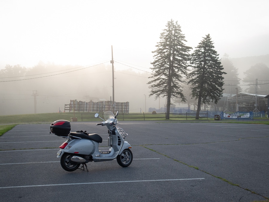 A Vespa GTS 250ie scooter parked on a foggy morning.