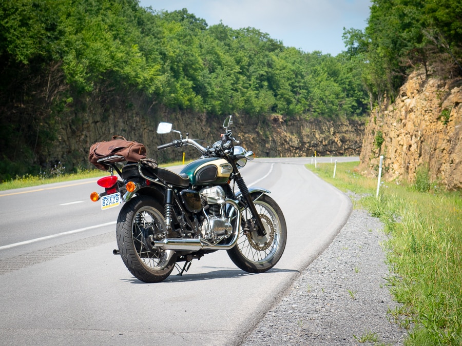 A 2001 Kawasaki W650 motorcycle parked along a highway.