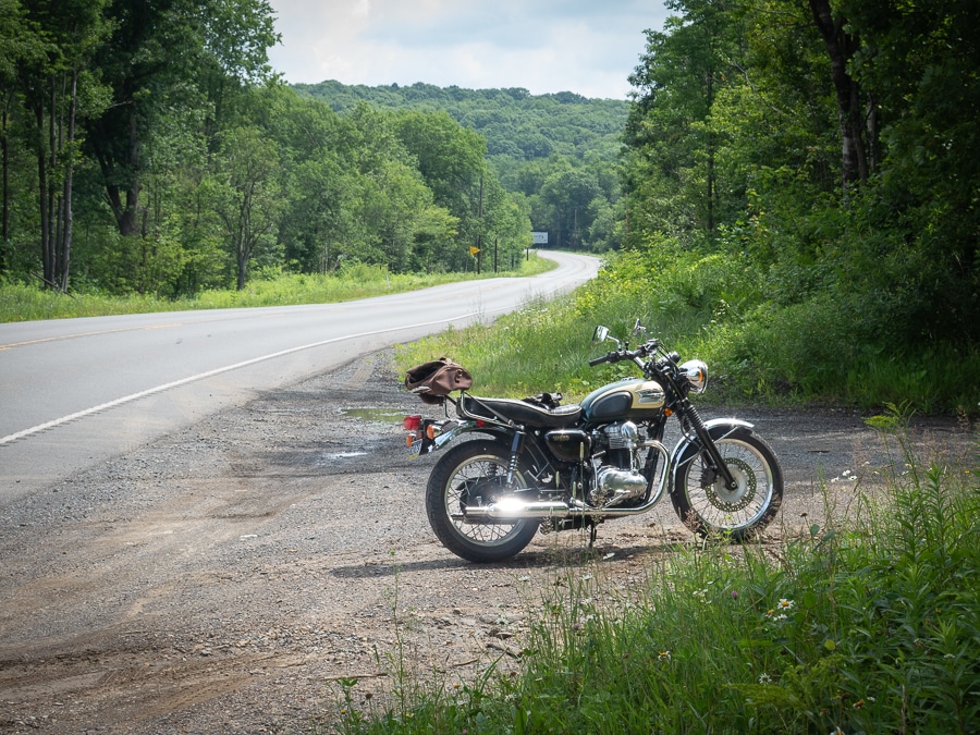 2001 Kawasaki W650 motorcycle parked alongside an empty rural highway.
