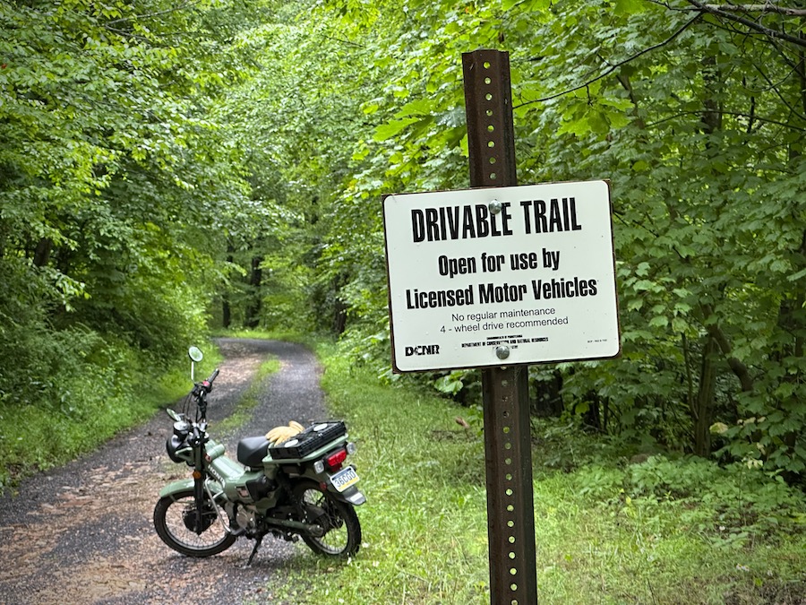 The Honda Trail 125 motorcycle parked on a trail.