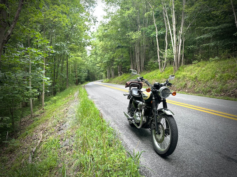 The 2001 Kawasaki W650 on a quiet, rural road.