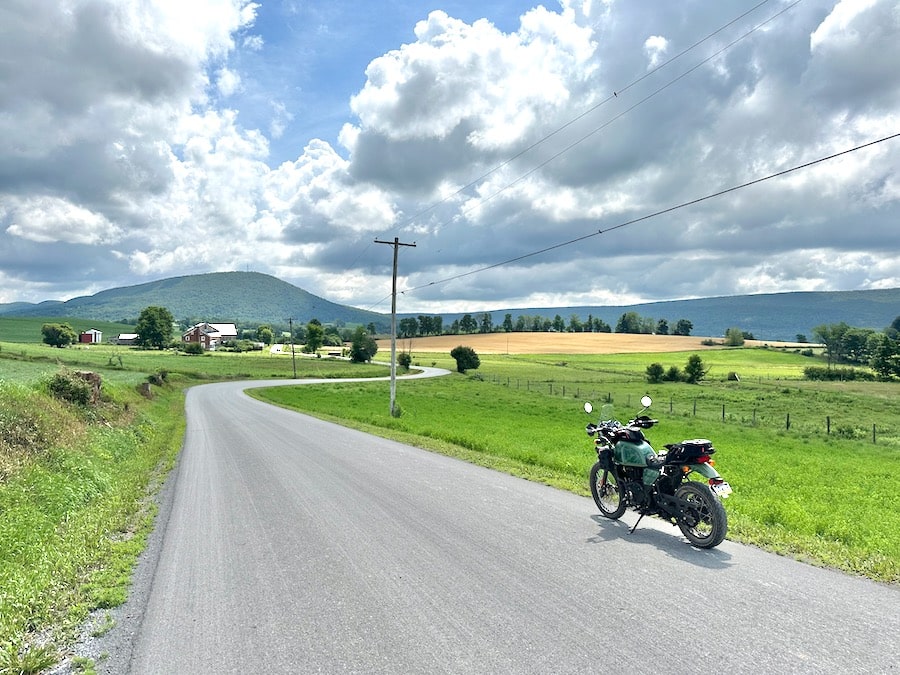 A 2022 Royal Enfield Himalayan along a rural road in farm country.