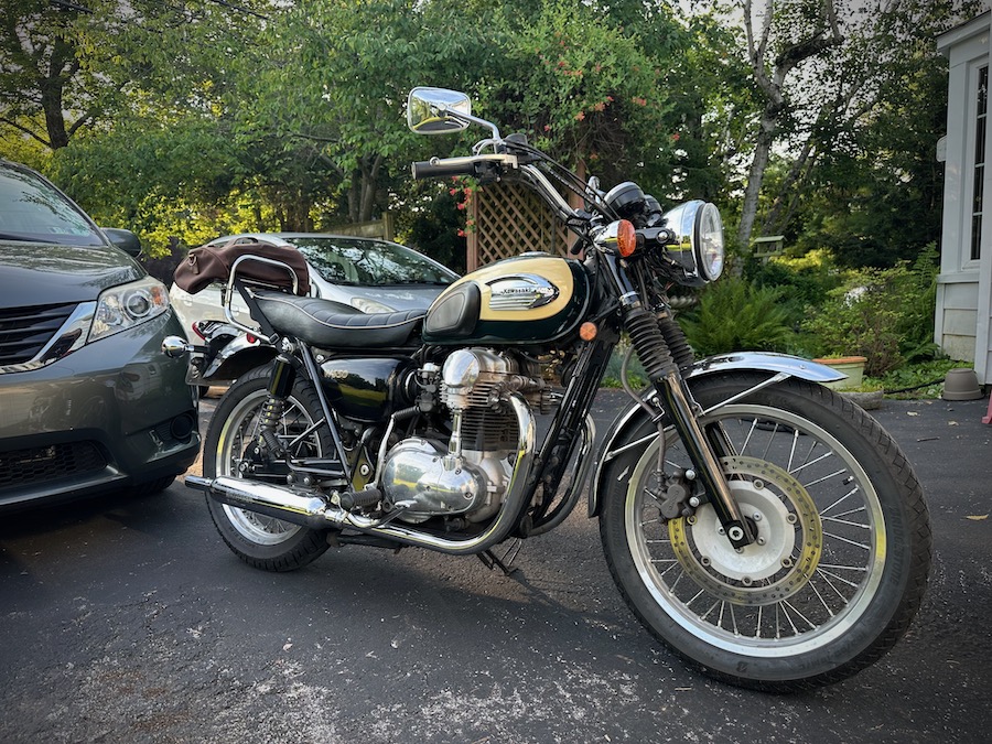 A 2001 Kawasaki W650 motorcycle parked in a driveway.