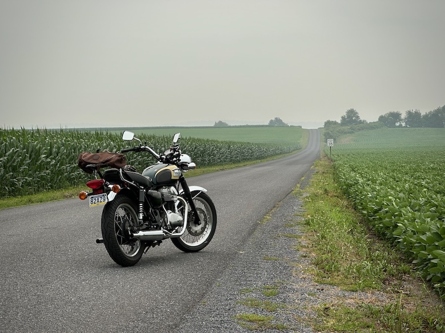 A 2001 Kawasaki W650 motorcycle parked on a rural road.