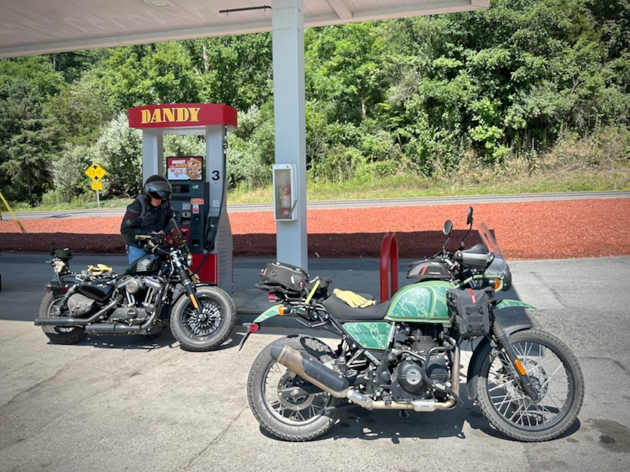 Two motorcycles at a gas station.