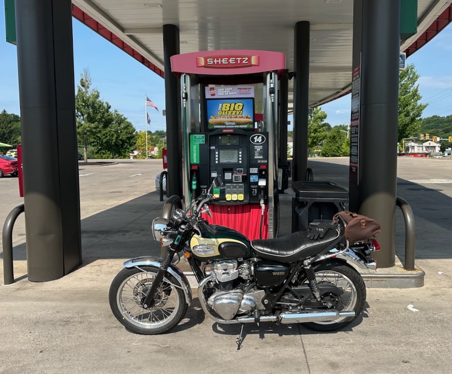 A 2001 Kawasaki W650 parked at a gas pump.