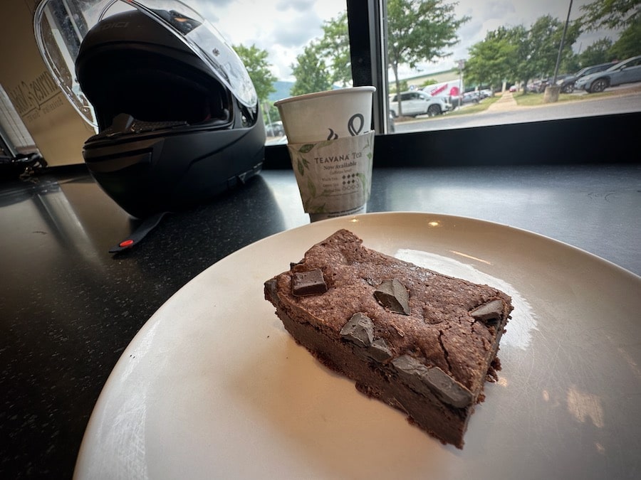 Chocolate brownie on a white plate.