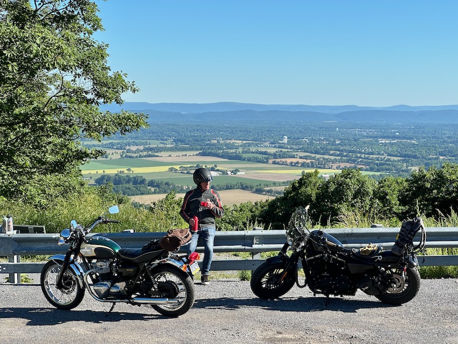 Two motorcycles parked at a scenic vista.
