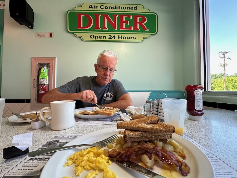 Man eating breakfast in a diner.