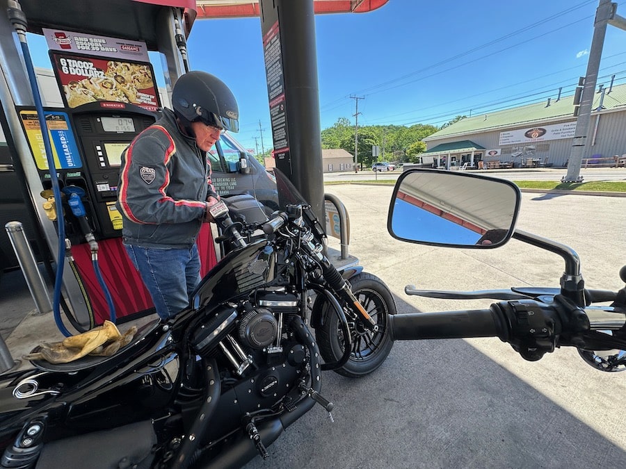 Man putting gas in a Harley-Davidson Forty-Eight motorcycle.