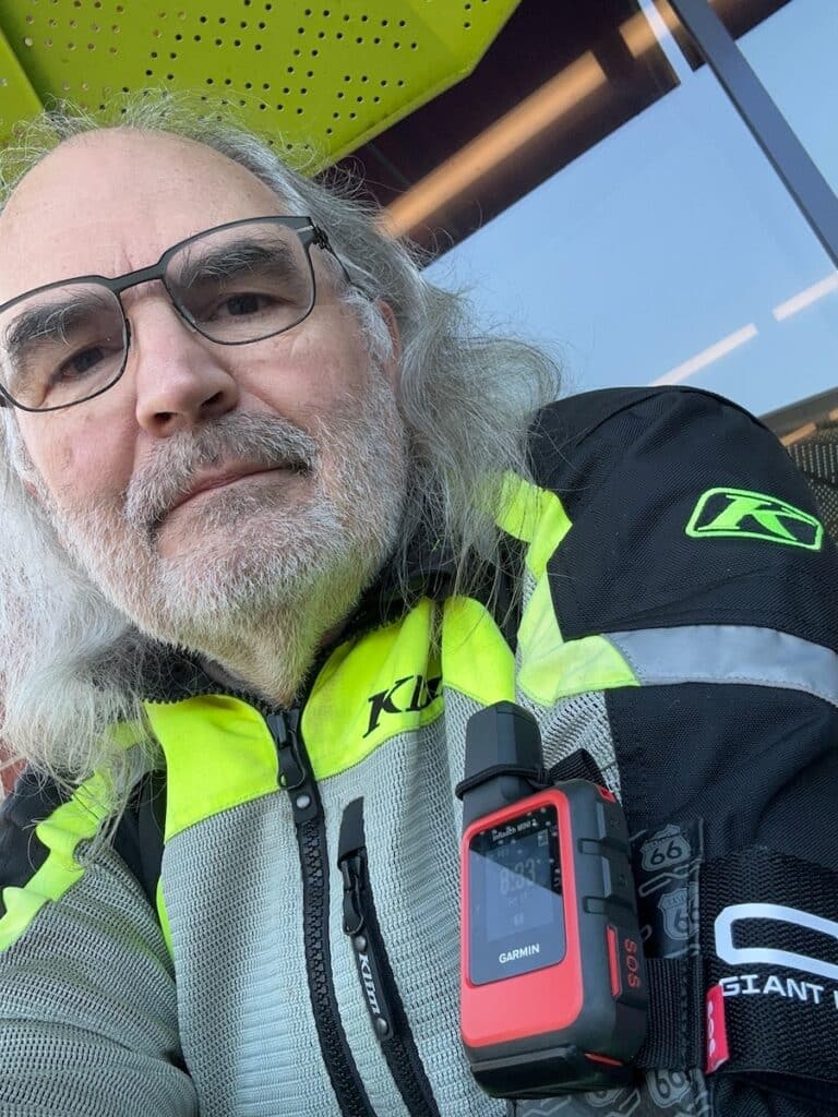 Steve Williams with a Garmin InReach Mini 2 device attached to the sleeve of his riding jacket.