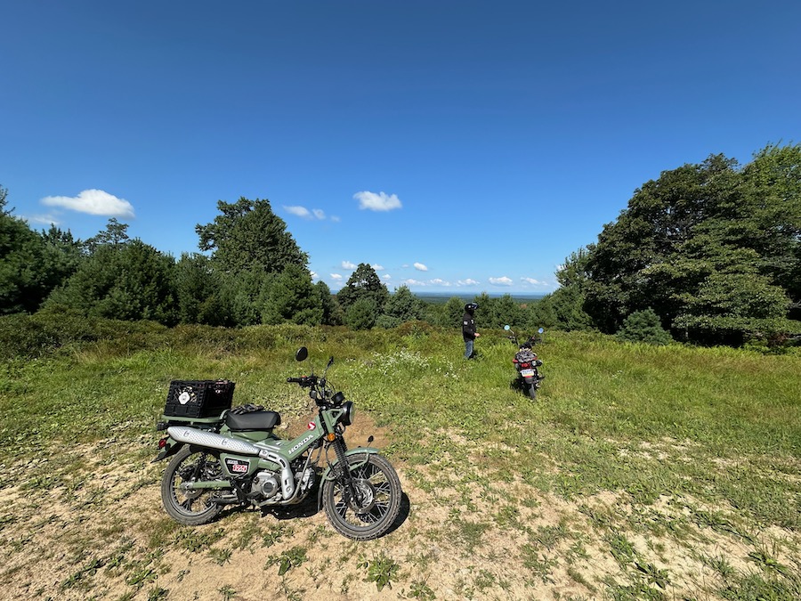 A Honda Trail 125 motorcycle parked at a scenic vista.