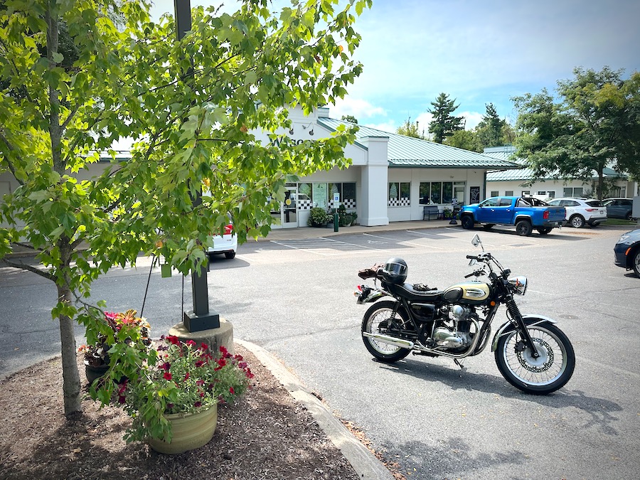A 2001 Kawasaki W650 motorcycle in a store parking lot.