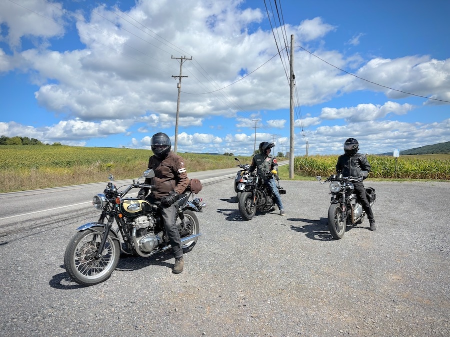 Three motorcycles along the road.