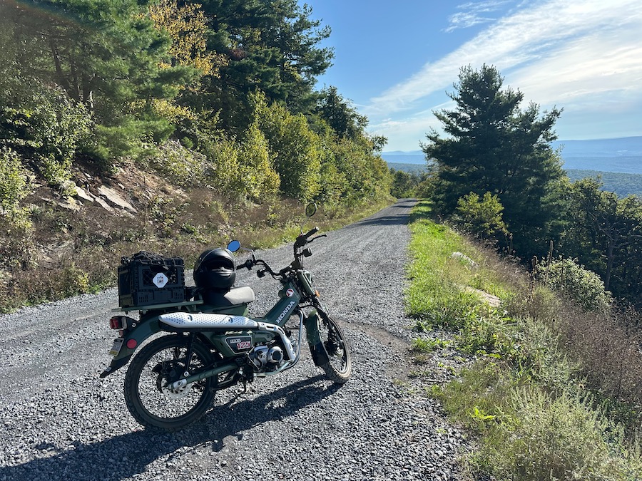 A Honda Trail 125 motorcycle parked at a scenic vista.