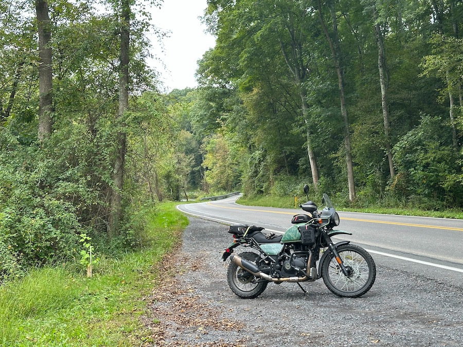 A 2022 Royal Enfield Himalayan motorcycle parked along a rural road.