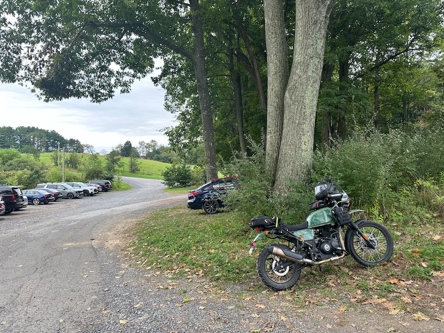 Motorcycle parked along a gravel parking lot.