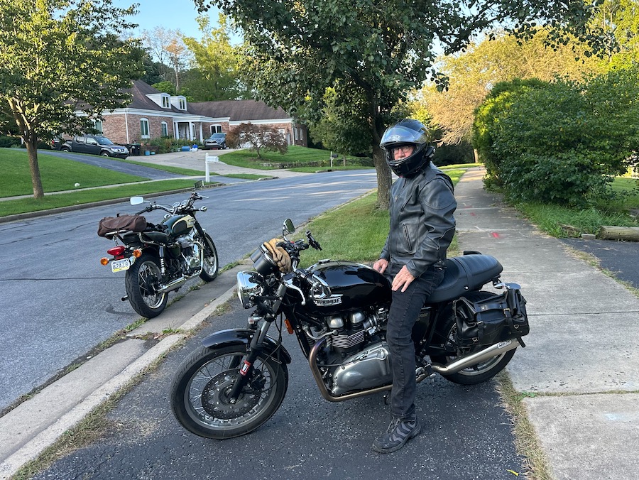 Man sitting on a Triumph motorcycle.
