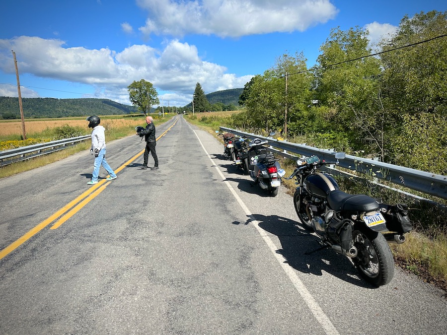 Motorcycles parked along a rural road.