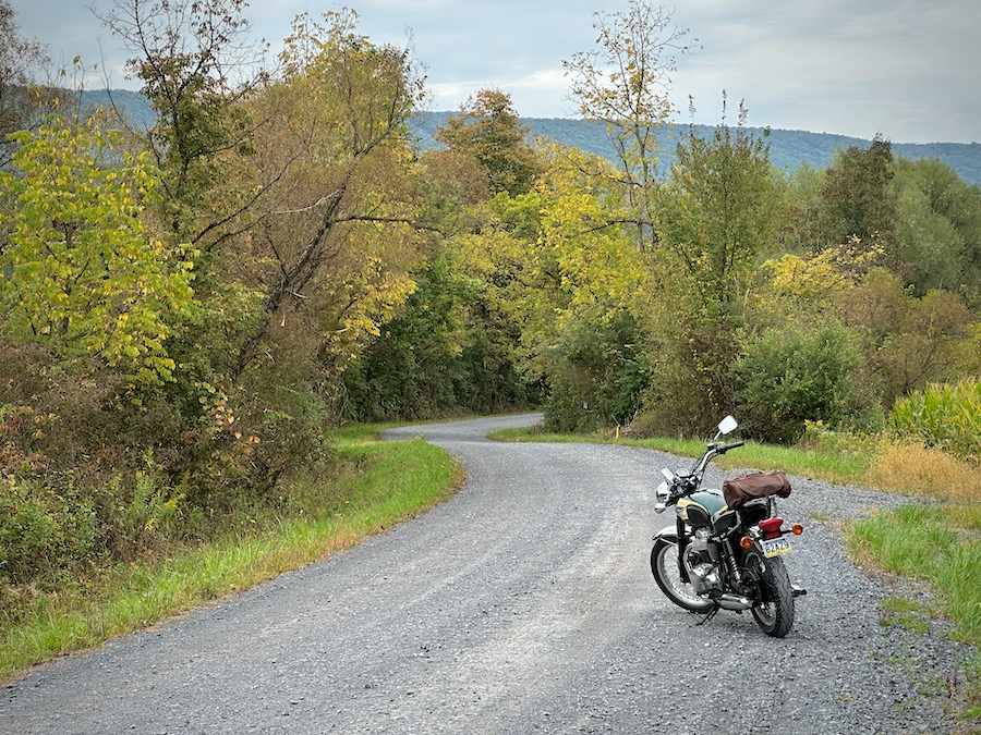 A 2001 Kawasaki W650 motorcycle on a rural gravel road.