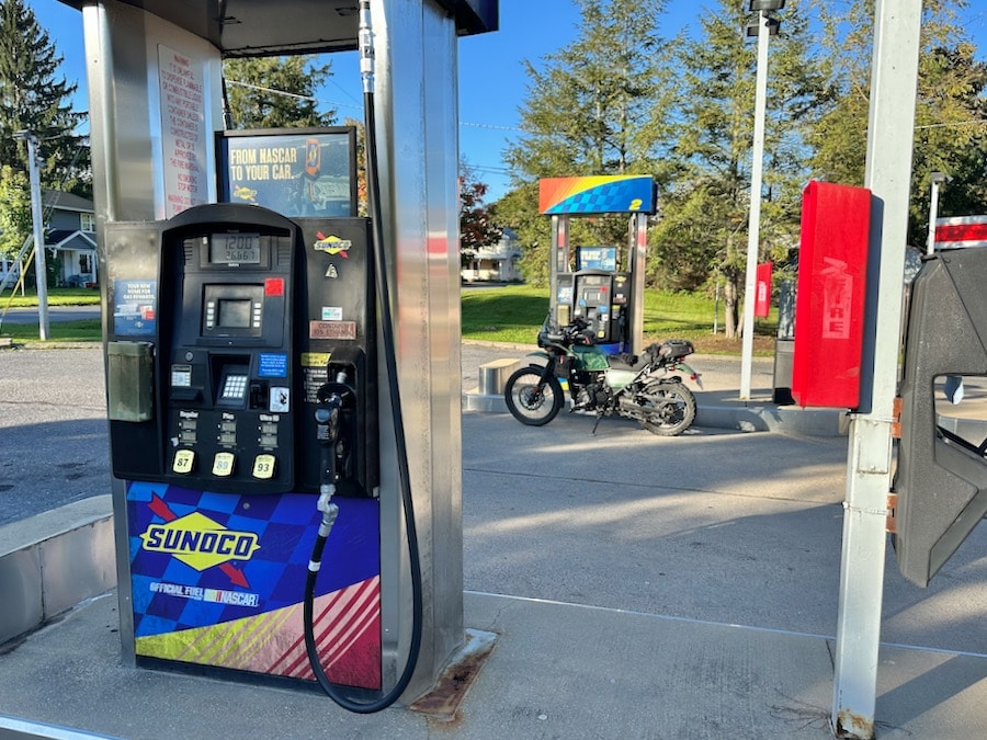 A Royal Enfield Himalayan parked at a gas pump.