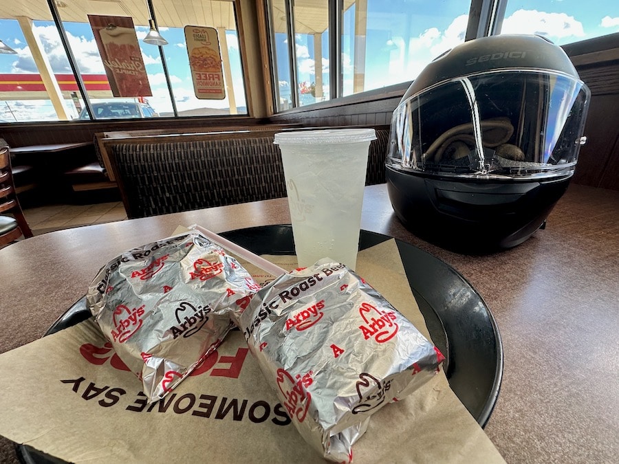 Two Arby's roast beef sandwiches on a tray in the restaurant.