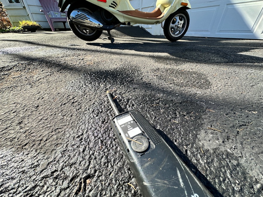 A damaged AirMoto portable air pump on the driveway.
