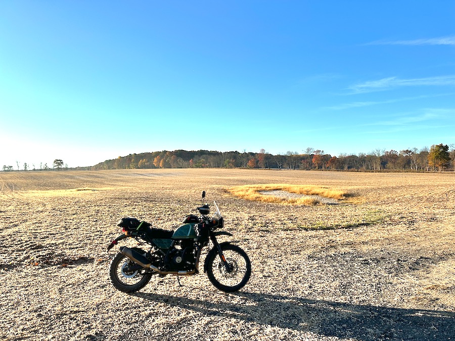 A 2022 Royal Enfield Himalayan parked in a farm field.